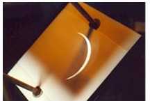 The partial eclipse crescent projected onto paper from the telescope
