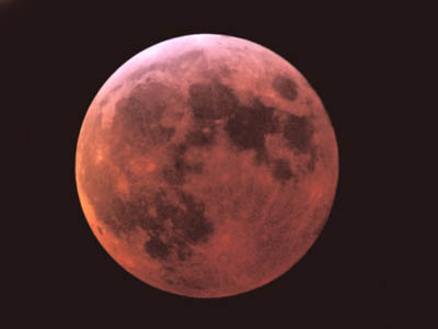 The totally eclipsed moon shines redly