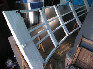 [The restored shutter frame primed, fitted with its
new rollers, and ready to be covered and re-installed (1.6MB)]